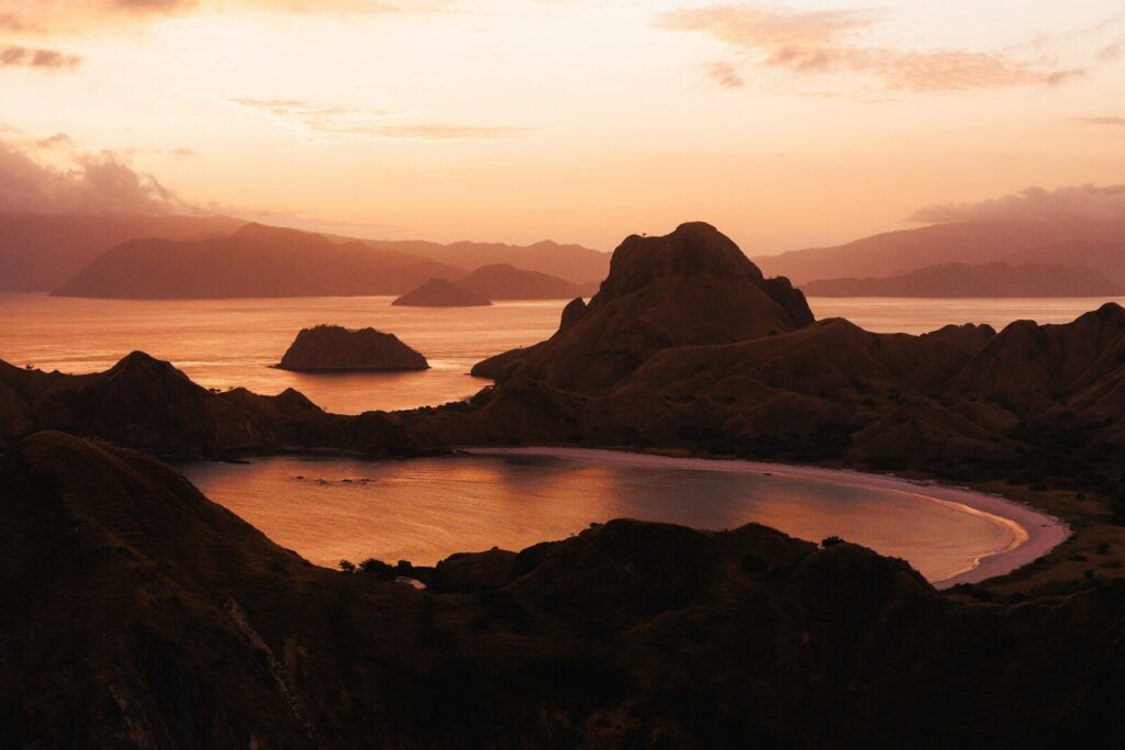 Hills and ocean at sunset with warm light